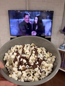 Creepy Eyeballs popcorn with chocolate drizzle and candy eyes during The Addams Family (1991).