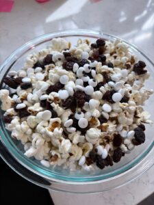 Button Eyes popcorn with candy eyeballs, yogurt raisins and white chocolate for a Coraline movie night.