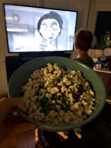Frankenstein popcorn with green candy melts and sprinkles during a Frankenweenie movie night.