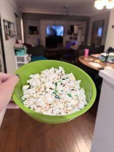 Slime Time popcorn with green sprinkles in a lime-green bowl for a Goosebumps movie night.