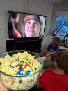 Magic Potion popcorn with M&Ms and vanilla melts while the twins watch Halloweentown.