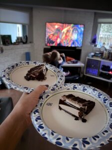Two slices of chocolate birthday cake on paper plates during a Hotel Transylvania: Transformania movie night.