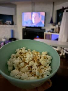 Cheesy Twin Magic popcorn in a mint bowl for a Twitches movie night.