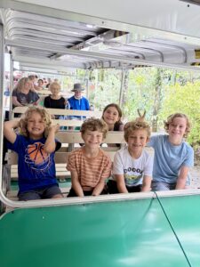 Group of homeschool kids smiling on the narrated tram tour at Flamingo Gardens Davie Florida